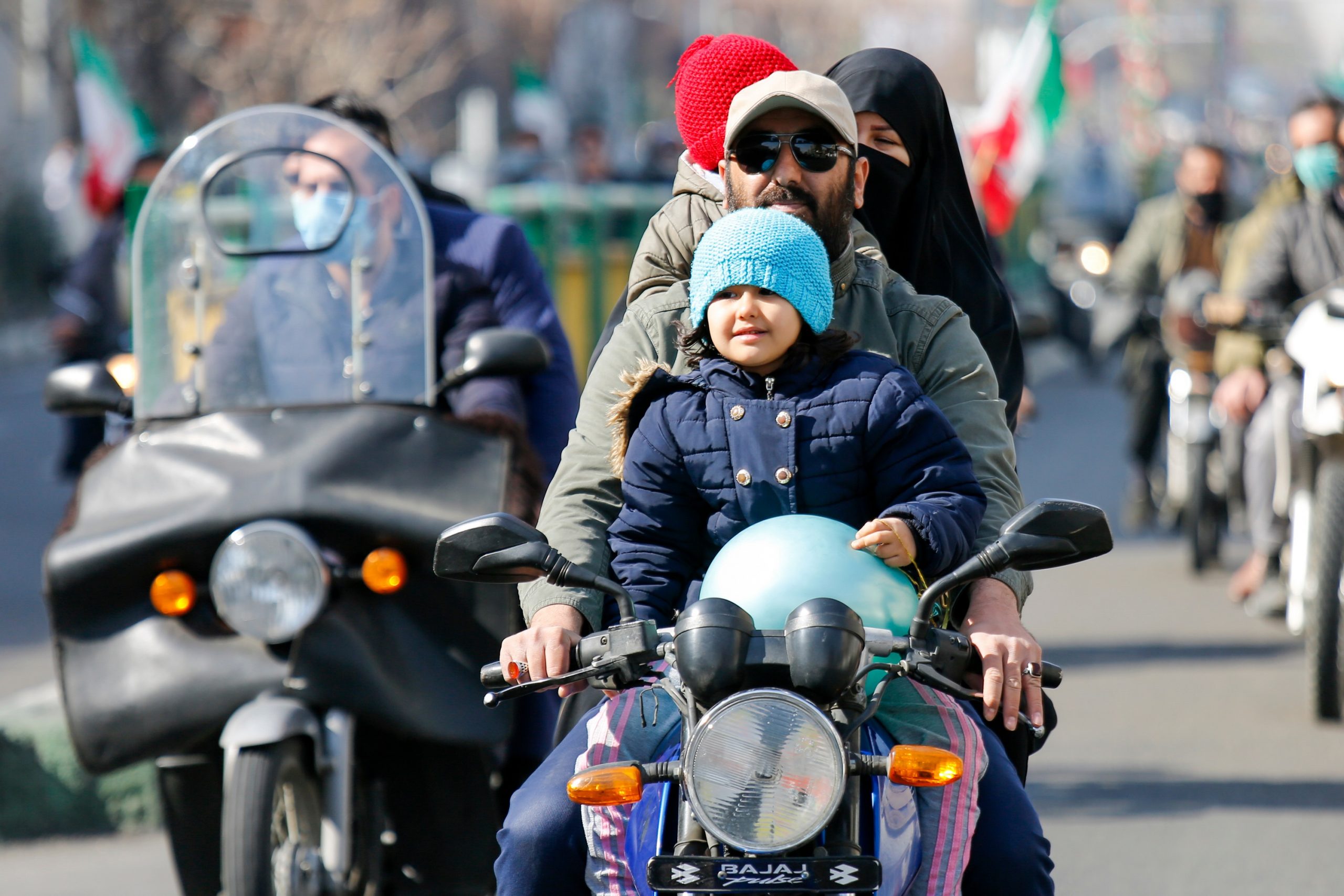 Tehran, Iran - February 10, 2021 -People took part in the drive-in rallies on their motorcycles amid the pandemic to commemorate the 42nd victory of the Islamic Revolution in 1979.